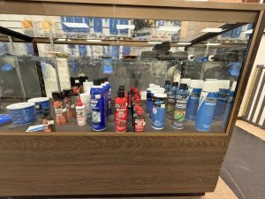 Bicycle maintenance products and lubricants displayed inside glass case in bike shop