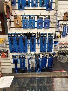 Close-up of bicycle repair tools in blue packaging on slatwall display