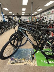 Mountain bikes on display with one bike in foreground on showroom floor in bicycle shop