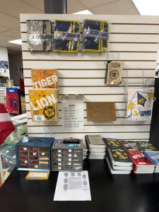 Display of scouting books, manuals, and accessories on retail wall and counter
